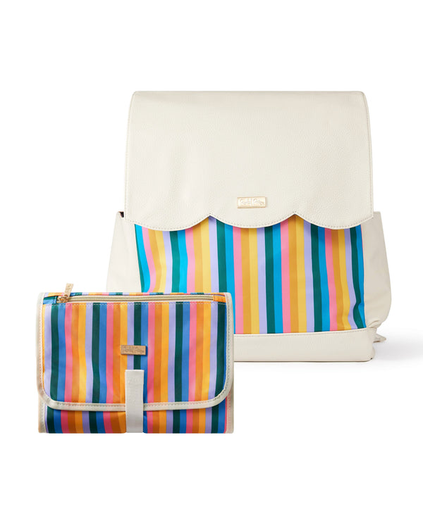 White and rainbow striped diaper bag backpack next to rainbow striped portable changing pad