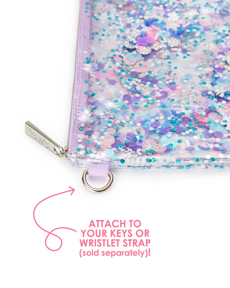 A zoomed in photo of a clear vinyl pouch with purple confetti displays the silver zipper and silver hoop attached to its side. A pink arrow points towards the hoop and the text reads, "Attach to your keys or wristlet strap (sold separately)!