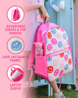A person holds a pink and white knit backpack with red, blue, pink and purple smiley faces on the exterior. To the left of the backpack, 3 icons display information about the backpack. The top one reads, "Adjustable straps and top handle." The second one reads, "Luxe jacquard fabric." The third one reads, "Laptop sleeve."