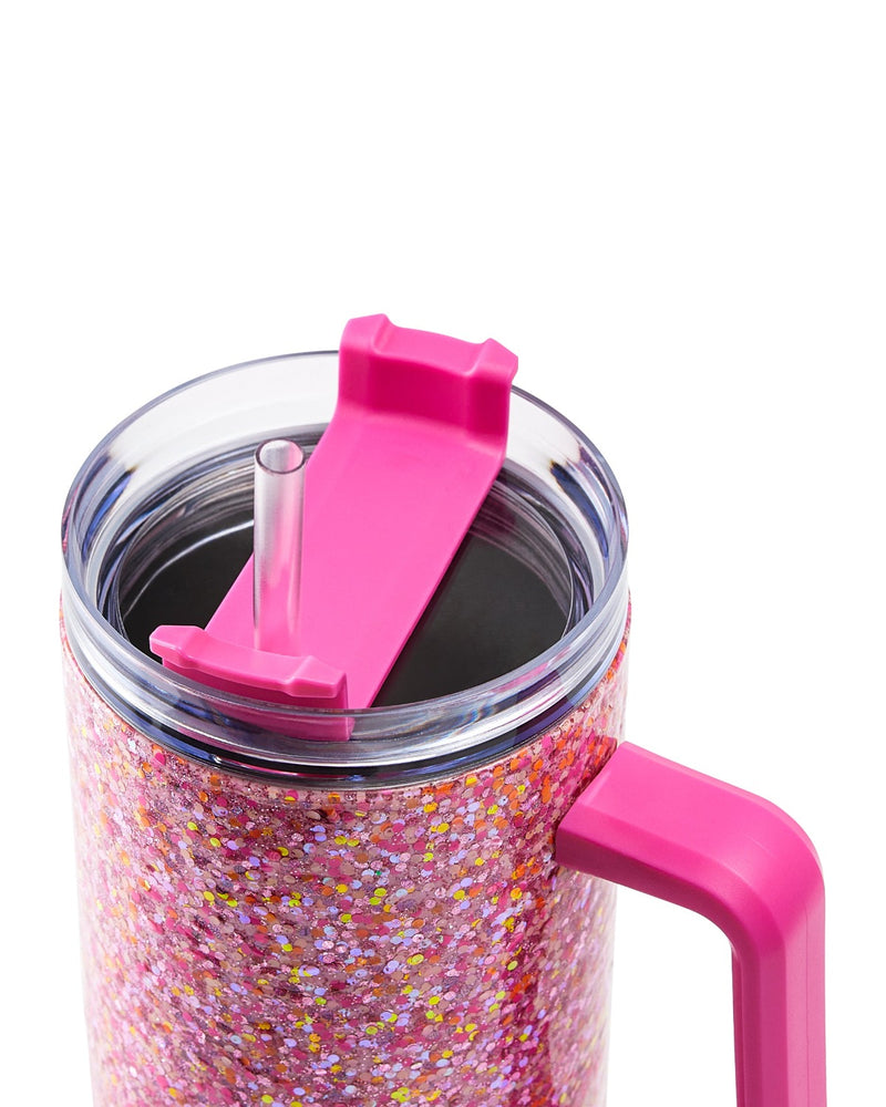 A pink glitter stainless steel tumbler stands against a white background. The picture is a close up on the tumbler's lid and straw.