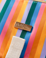 Close up shot of rainbow stripes and gold Packed Party logo on changing pad