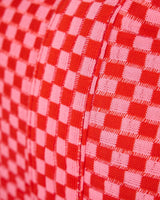 Close up shot of fabric and pink and red checkered pattern. 