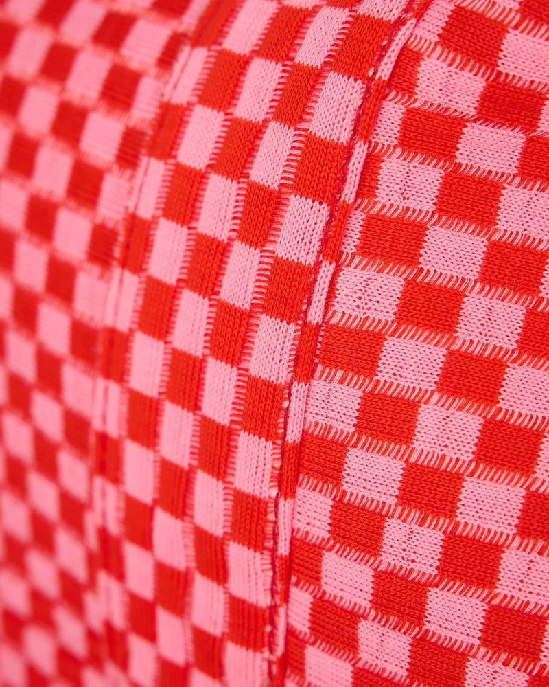 Close up shot of fabric and pink and red checkered pattern. 