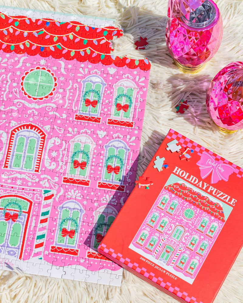 Gingerbread house puzzle and ornament sippers shot against white fur background. 