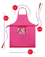 Pink apron with red scalloped edge, red trim details, and trapped confetti pocket shot against white background with dimensions . Height is 33.5", width is 27", length of side straps is 27.5", and length of neck strap is 22". 