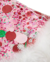 Close up of pink, red, white, and green confetti in pink trapped confetti santa hat with faux fur trim. 