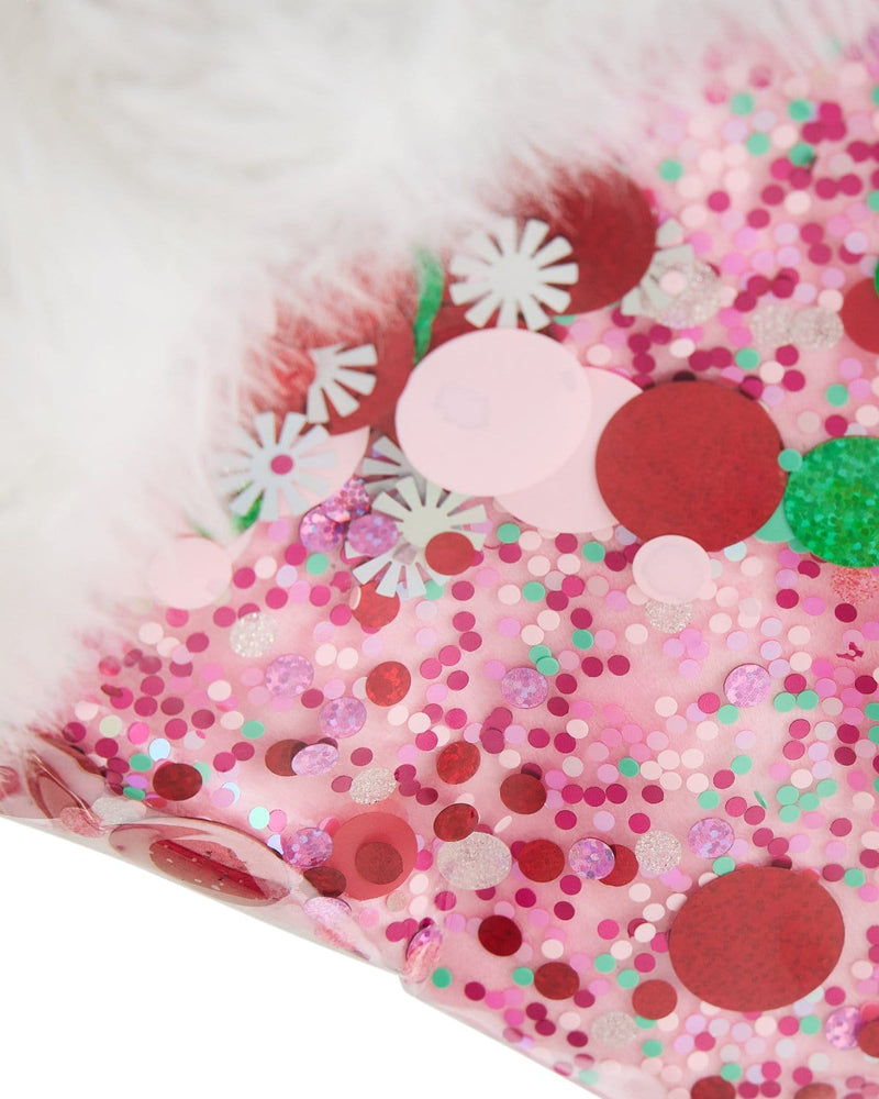 Close up of pink, red, white, and green confetti and faux fur trim. 