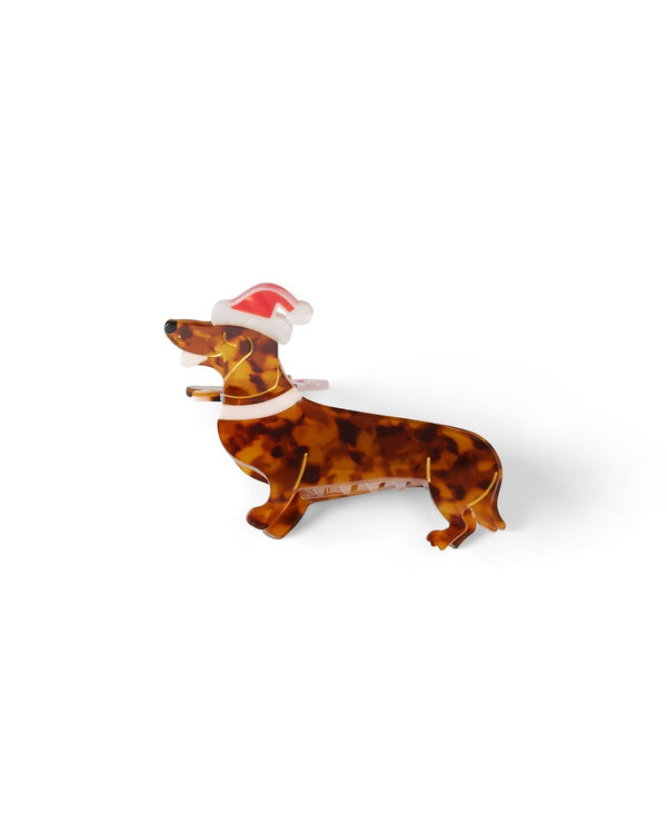 Santa dog claw clip with red Santa hat shot against white background. 