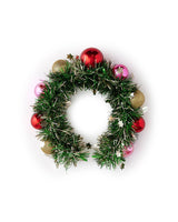 Colorful wreath headband with green tinsel and ornament details shot against white background. 