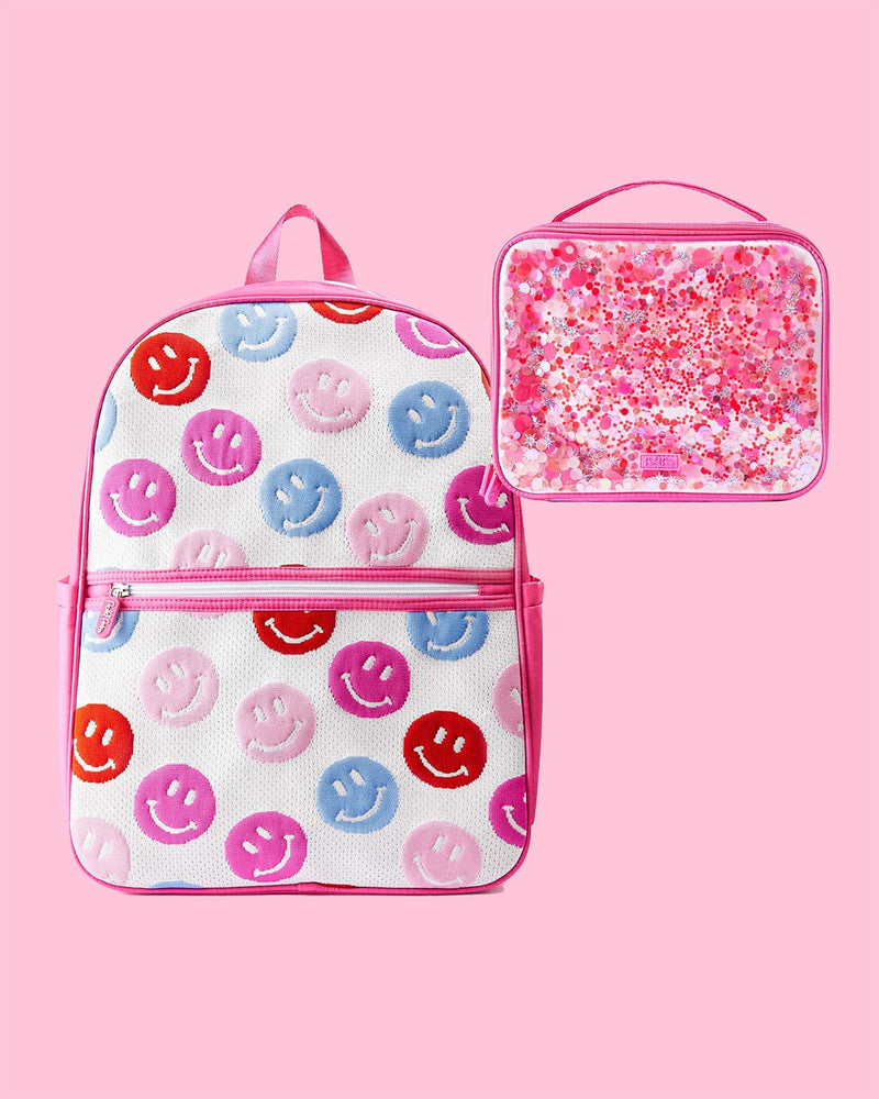 Smiles for Miles Backpack and Sweet Tart Confetti Lunch Box against pink background