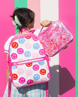 stylish girl with Smiles for Miles Backpack and Sweet Tart Confetti Lunch Box