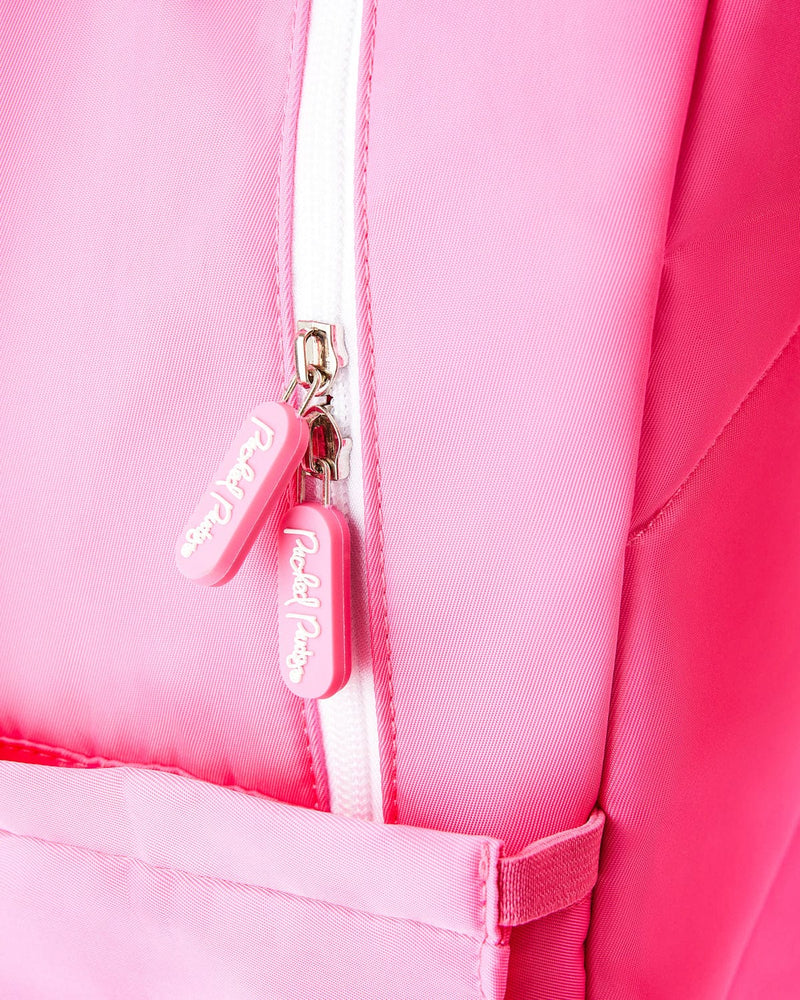 Close up view of the pink and white knit backpack. The image is zoomed in, and focuses soley on two pink zippers that read "Packed Party" in white script text.